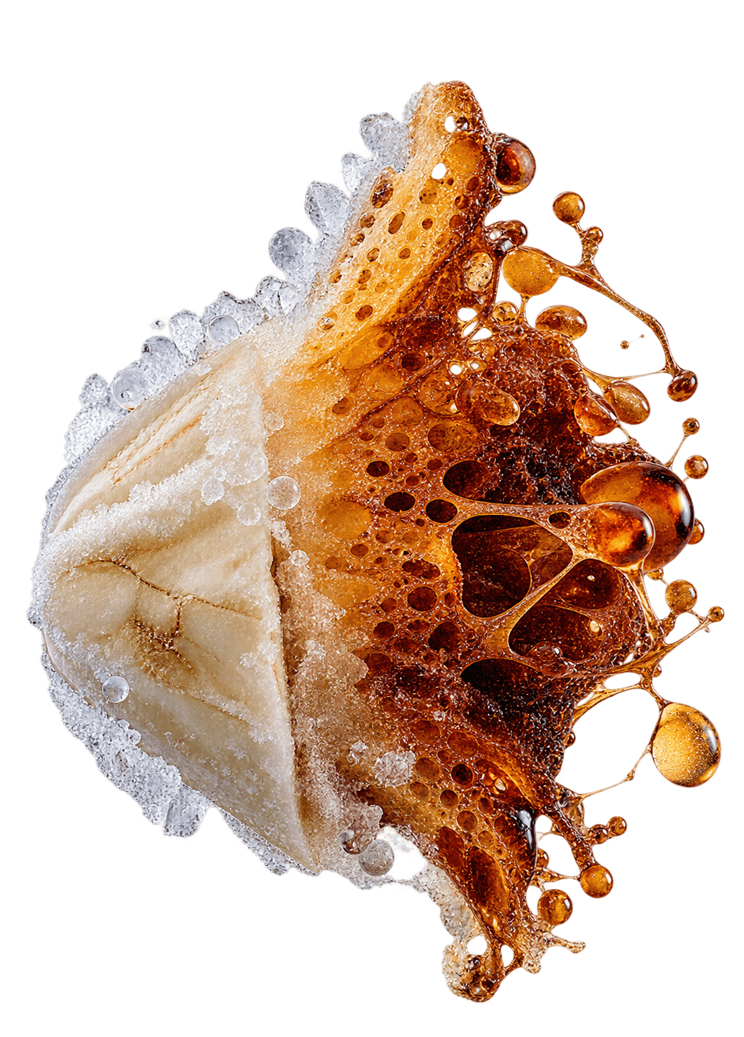 A frozen banana half dusted in frost, its cut face bubbling into dark amber caramel with drops flying off.